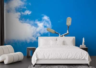 Solar cells LED light in blue sky with clouds. Wall mural