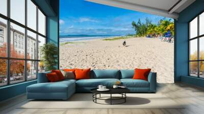 Clear and dense sand against blue sky with clouds and strong sun on beach Wall mural