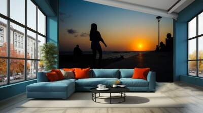 Silhouette of people at dramatic sunset. City of Salvador, Bahia, Brazil. Wall mural