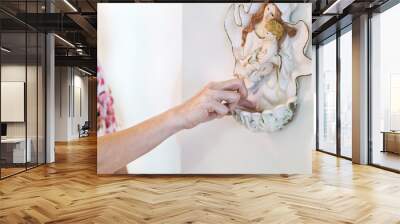 catholics dipping finger into font containing holy water Wall mural