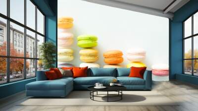 Colorful macarons like graph decreasing on white backgound, selective focus Wall mural