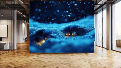 A serene blue landscape with glowing features beneath falling snowflakes, evoking tranquility and magic in winter scenery. Wall mural