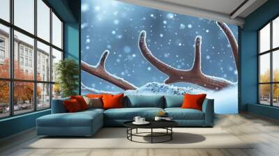 A serene winter scene featuring antlers partially buried in fresh snow, surrounded by a soft, snowy background and gentle snowfall. Wall mural