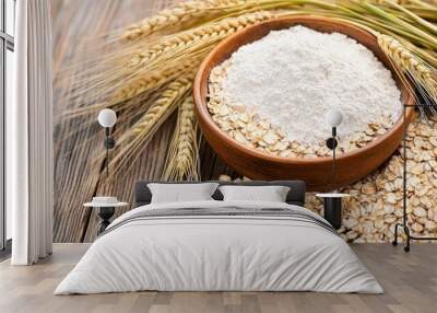 Bowl of flour with oats and wheat ears on rustic wooden surface Wall mural