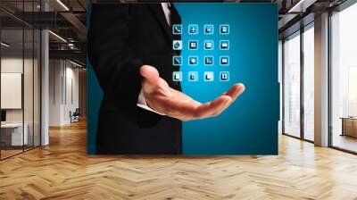 Business Man hold application icons on his hand Wall mural