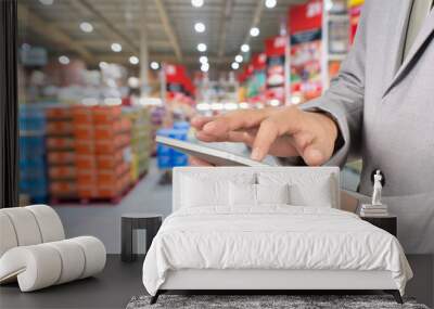 Hand of Businessman, Manger use Mobile Tablet in supermarket Wall mural