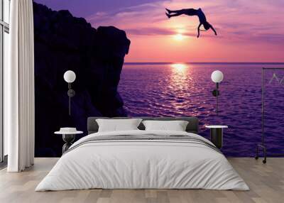 Asian girls jump from a cliff into the sea episode sunset,Somersault to the ocean  Wall mural