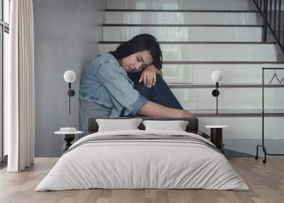 Close up sad woman sitting at staircase in apartment.Sad,depression concept. Wall mural