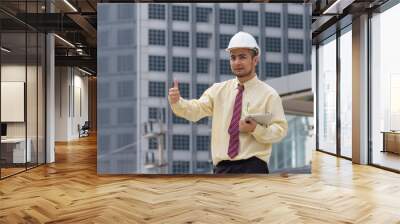 Business man thumbs thumb A confident stance, with the backdrop of the buildings in the city. Wall mural