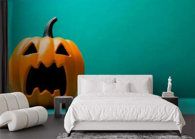 A carved, angry Halloween pumpkin stands in front of a teal background, showcasing its spooky facial expression for festive vibes. Wall mural