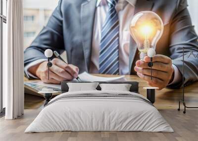 Businessman Holding Light Bulb Idea for Financial Growth. Wall mural