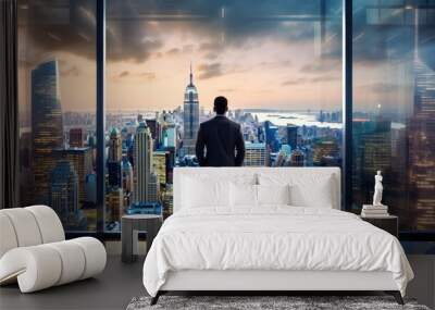 Full back view of successful businessman in suit standing in office. CEO looks at big city view through window in office. Wall mural