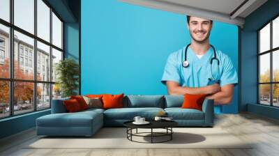 Portrait of a smiling happy male medical doctor or nurse standing isolate on blue background, Medical concept. Wall mural