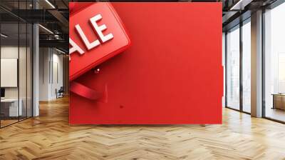 Vibrant red background with a bold 'SALE' tag and decorative ribbons, perfect for promotional offers and discounts. Wall mural