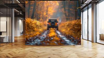 A jeep is driving down a dirt road in a forest Wall mural