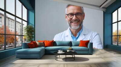 A smiling man in a white lab coat with a pair of blue glasses Wall mural