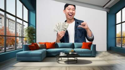 Cheerful man jeans shirt smile and happy about earn money point finger at himself isolated Wall mural