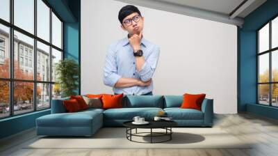 Young businessman feels doubt gesture hesitate looking at copy space Wall mural