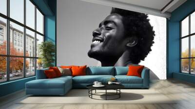 A black and white portrait of a young man,  smiling with genuine joy and radiating positivity. His afro hairstyle adds a touch of individuality, while the black and white tones  Wall mural