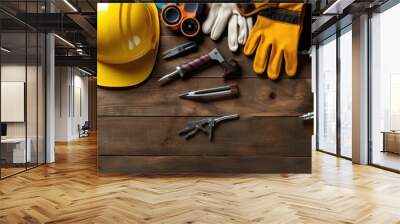 Crafting Excellence: Builder Tools Flatlay Featuring Wrench, Safety Glasses, and Gloves on Wooden Surface Wall mural