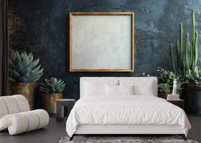 Elegant display of succulents with a blank frame on textured wall Wall mural