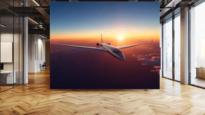 Majestic Commercial Airliner Flying in Clear Blue Sky at Sunrise with Warm Hues on Wings Wall mural