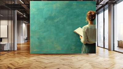 Woman reading a book against a textured teal wall Wall mural