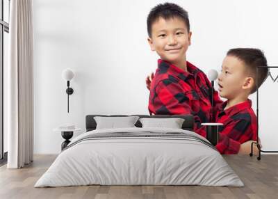 Brothers embracing, two boys wearing red team shirt isolated on white Wall mural