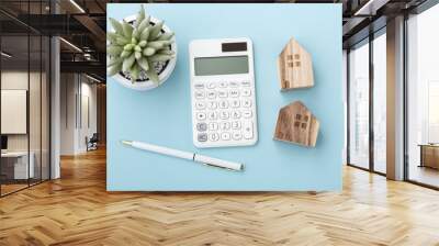 Calculator with house model, home loan or mortgage concept Wall mural