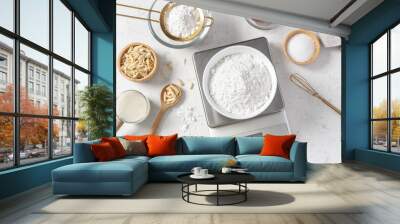 Flour in white bowl measuring on digital scale with cake or bakery ingredients and utensil on marble kitchen table Wall mural