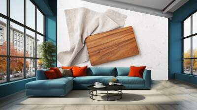 Wooden cutting board with linen napkin on marble table Wall mural