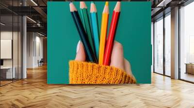 A hand holding a vibrant collection of colored pencils perfectly shading a beautiful m gigapixel standard artwork Wall mural