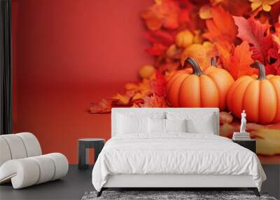 Two pumpkins with vibrant fall leaves on an orange background, representing the autumn season and Thanksgiving holiday. Wall mural