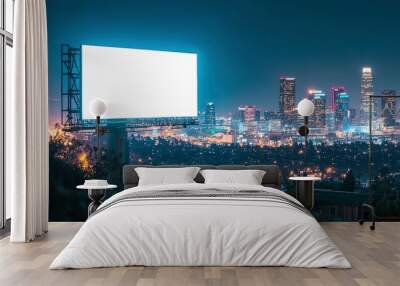 A blank billboard illuminated against the backdrop of a city skyline at night  Wall mural