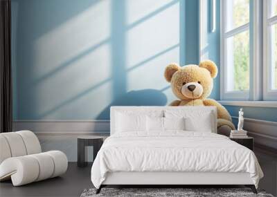 A plush teddy bear sits on a wooden floor in a room with a light blue wall and a window, perfect for a cozy nursery or playroom. Wall mural