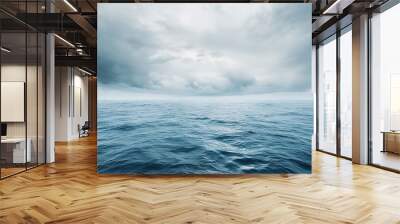 Calm ocean with overcast sky. Seascape photography with stormy weather. Ocean and sky interaction concept. Design for poster and wallpaper. Wide view with copy space Wall mural