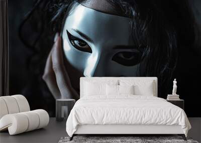 Mysterious woman holding white mask in dramatic lighting Wall mural