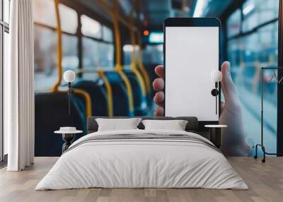 Person hand holding isolated smartphone device in the bus with blank empty white screen, communication transportation technology concept Wall mural