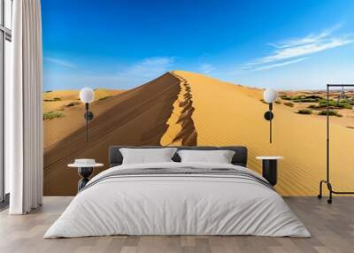 A vast desert landscape with towering sand dunes, under a clear blue sky, showcasing the rugged beauty of natureâ€™s barren yet scenic terrain. Wall mural