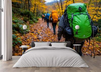 Autumn hike through a forest, captured in a photo where hikers walk along a leaf-covered trail, with the vibrant colors of autumn surrounding them and the crisp air invigorating their journey Wall mural