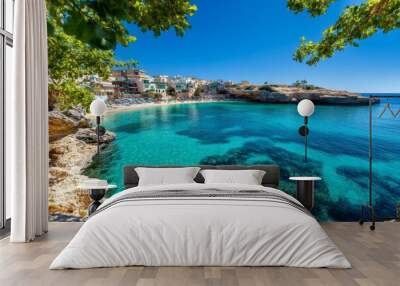 Popeye Village in Malta, nestled along a rocky coastline with colorful wooden houses, and the blue Mediterranean Sea in the background Wall mural