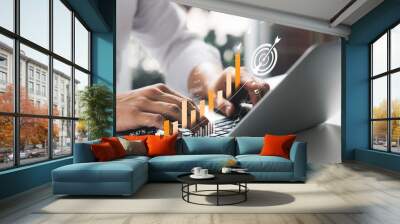 Businessman analyzing company's financial balance sheet working with digital augmented reality graphics. Businessman calculates financial data for long-term investment. Wall mural