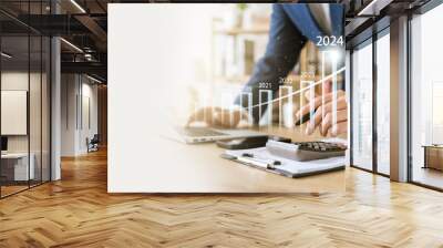 businessman new year business goals 2024, positive indicators 2024, company competitiveness on global scale, businessman calculating financial data for long term investments. Wall mural