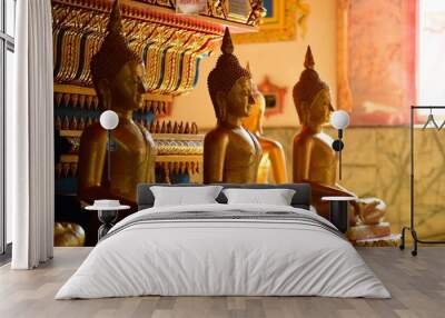 Golden statue of buddha in temple, Thailand Wall mural