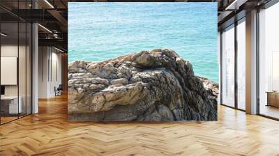 Sea water with waves and rocks at the beach Wall mural