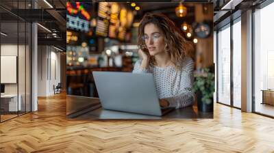 Woman Conducting Financial Research on Laptop at Cafe for Diversified Investing Wall mural