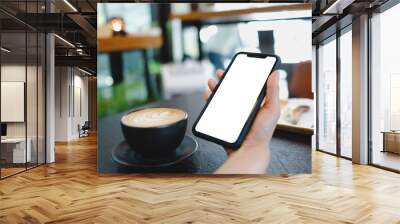 Close up of woman using mobile blank smart phone and credit card sending massages in the coffee shop Wall mural