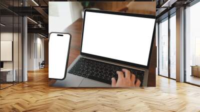 mockup image computer,cell phone blank screen for hand typing text,using laptop contact business searching information in workplace on desk at office.design creative work space on wooden desk Wall mural