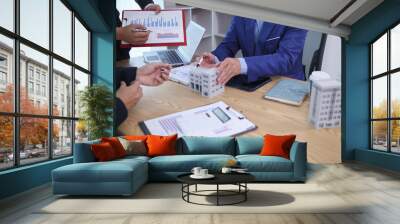 group of businessmen and investors discuss investing in real estate and jointly plan investments in construction projects of condominiums and apartments for sale and rent. investment advisory concept Wall mural