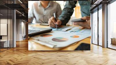 A financial advisor assisting a small business owner in creating a budget plan, focusing on managing expenses, forecasting growth, and ensuring financial stability Wall mural